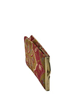 A vintage folding clutch wallet with a red and gold paisley patterned fabric cover and gold-tone metal clasp,