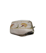 A small vintage coin purse with a white satin fabric cover featuring embroidered flowers and gold stripes, secured by a silver-tone metal clasp.